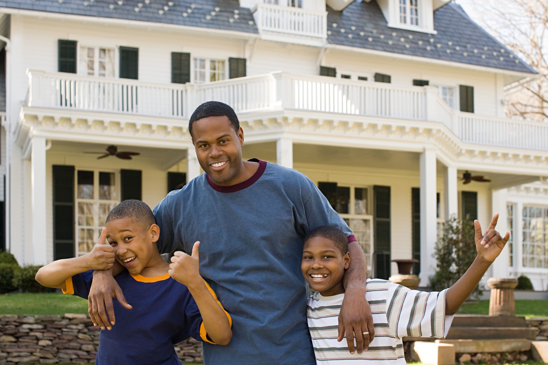 Father and sons outside house